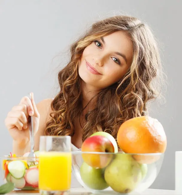 Young cute girl having breakfast